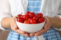 Woman holds bowl with fresh red cherry Royalty Free Stock Photo