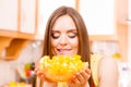 Woman holds bowl full of sliced orange fruits Royalty Free Stock Photo