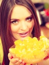 Woman holds bowl full of sliced orange fruits Royalty Free Stock Photo