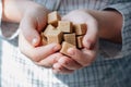 Woman holds brown sugar cubes in hands. Royalty Free Stock Photo