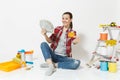 Woman holds bundle of dollars, cash money, credit card sits on floor with instruments for renovation apartment isolated Royalty Free Stock Photo