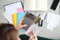 Woman holds calculator and paid check closeup