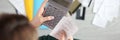 Woman holds calculator and paid check closeup