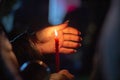 A woman holds a candle in her hand, covering the flame from the wind with her palm, in memory of the dead, killed, dead, deceased Royalty Free Stock Photo