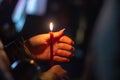 A woman holds a candle in her hand, covering the flame from the wind with her palm, in memory of the dead, killed, dead, deceased Royalty Free Stock Photo