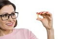 Woman holds a capsule with vitamin E, fish oil. White background, isolated, focus on the capsule Royalty Free Stock Photo