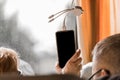 A woman holds and charges a phone on the bus using a modern USB charger with various adapters