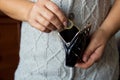 The woman holds the coins over the old empty wallet. The concept of poverty. Royalty Free Stock Photo