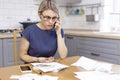 A woman holds coins in the river and talks on the phone. Royalty Free Stock Photo