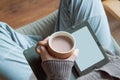 A woman holds a cup of cocoa in her hand and reads a book. Royalty Free Stock Photo