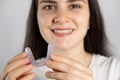 A woman holds dental mouthguard, splint for the treatment of dysfunction of the temporomandibular joints, bruxism