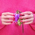 A woman holds a dry purple flower in her hands. Withered love after a relationship and a wedding