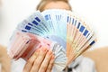 Woman holds euro money banknotes