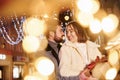 Woman holds gift box. Happy young couple celebrating New year outdoors on the street Royalty Free Stock Photo