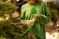 Woman holds gingerbread in a form of Christmas tree Royalty Free Stock Photo