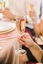 Woman hand holds glass of champaigne. Focus on wine glass Royalty Free Stock Photo