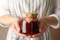 Woman holds glass jar with strawberry jam close up Royalty Free Stock Photo