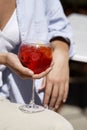 Woman holds glass with red cocktail, close-up Royalty Free Stock Photo