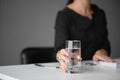 Woman holds a glass of water in her hands. Office. Businessman. Close-up
