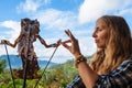 Woman holds in hand traditional Indonesian shadow puppet - Wayang Kulit