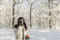 A woman holds a handful of snow in her hands and blows on it. Wi Royalty Free Stock Photo