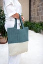 Woman holds a handmade knitted bag outdoors. Sustainable shopping. Wasteless lifestyle Royalty Free Stock Photo