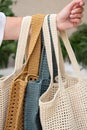 Woman holds a handmade many knitted bags outdoors. Sustainable shopping. Wasteless lifestyle Royalty Free Stock Photo