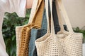 Woman holds a handmade many knitted bags outdoors. Sustainable shopping. Wasteless lifestyle Royalty Free Stock Photo