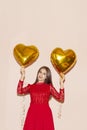 Woman holds heart shaped golden air balloons. valentines day, birthday, womens day, anniversary, holiday celebration concept Royalty Free Stock Photo