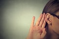Woman holds her hand near ear and listens carefully Royalty Free Stock Photo