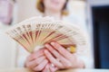 a woman holds in her hands a fan of Russian banknotes of 100 rubles. Royalty Free Stock Photo