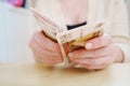 a woman holds in her hands and recalculates Russian banknotes of 100 rubles. Royalty Free Stock Photo