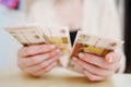 a woman holds in her hands and recalculates Russian banknotes of 100 rubles. Royalty Free Stock Photo