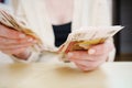 a woman holds in her hands and recalculates Russian banknotes of 100 rubles. Royalty Free Stock Photo