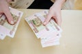 a woman holds in her hands and recalculates Russian banknotes of 100 rubles. Royalty Free Stock Photo