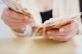 a woman holds in her hands and recalculates Russian banknotes of 100 rubles. Royalty Free Stock Photo