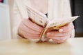 a woman holds in her hands and recalculates Russian banknotes of 100 rubles. Royalty Free Stock Photo