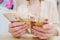 a woman holds in her hands and recalculates Russian banknotes of 100 rubles. Royalty Free Stock Photo