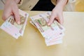 a woman holds in her hands and recalculates Russian banknotes of 100 rubles. Royalty Free Stock Photo