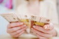 a woman holds in her hands and recalculates Russian banknotes of 100 rubles. Royalty Free Stock Photo