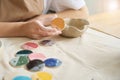 Woman holds sample palette paint for clay products in her hands Royalty Free Stock Photo