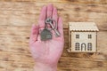 A woman holds a house key in her hand. Mortgage loan approval home loan and insurance concept