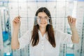 Woman holds huge decorative glasses, optic store