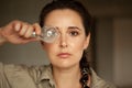 Woman holds incandescent light bulb in front of her