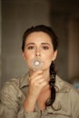 Woman holds incandescent light bulb in front of her