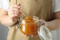 Woman holds jar with honey mustard sauce Royalty Free Stock Photo