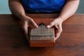 Woman holds Kalimba in her hands and plays it like a piano. Folklore musical instruments concept. Kalimba, acoustic music