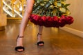 Woman holds luxury bouquet of red roses.