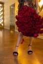 Woman holds luxury bouquet of red roses.