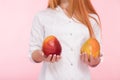 Woman holds mango in hands isolated on background Royalty Free Stock Photo